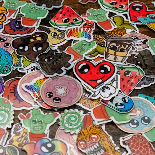 Collection of colorful cartoon-style stickers on a wooden surface