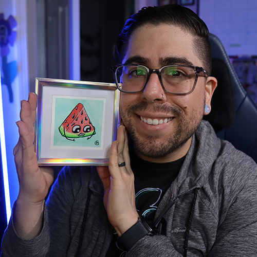 Man holding a water color painting of a watermelon monster in an irredescent square frame.