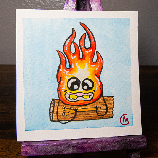 A small, original watercolor painting featuring a cartoon-style fire monster with a smiling face, painted on watercolor paper, with a white border and a purple easel.