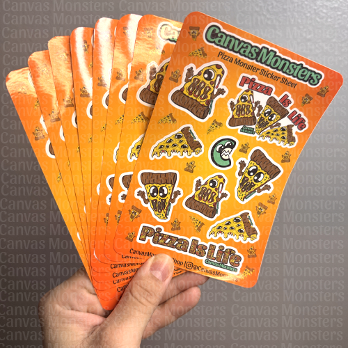 Hand holding eight sheets of pizza-themed Canvas Monster stickers.