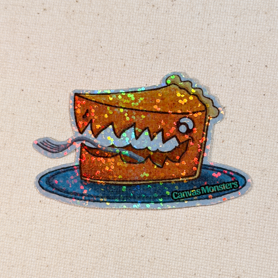 Glitter sticker of a cartoon pie with a face on a plate, branded 'Canvas Monsters', on a textured beige background