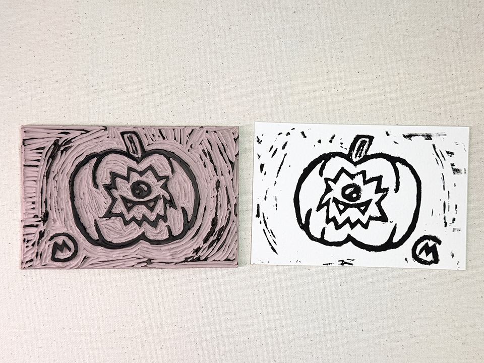 Punkin print stamp next to the stamped art on white paper