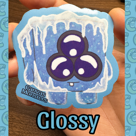 A sticker of a cute, cartoon-style ice monster with blue and purple eyes, part of the Canvas Monsters series.