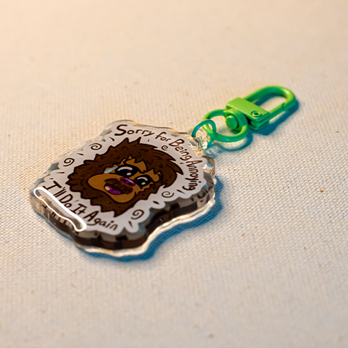 Keychain with Freddie the Yeti surrounded by the words "Sorry for Being Annoying, I'll Do It Again"