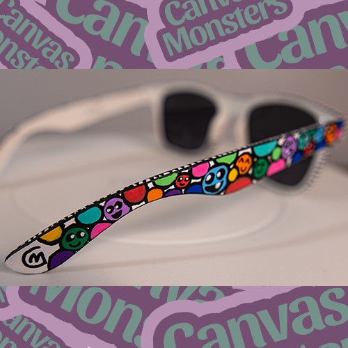 Close up photo of the side of painted sunglasses, showing the painted dots with faces.