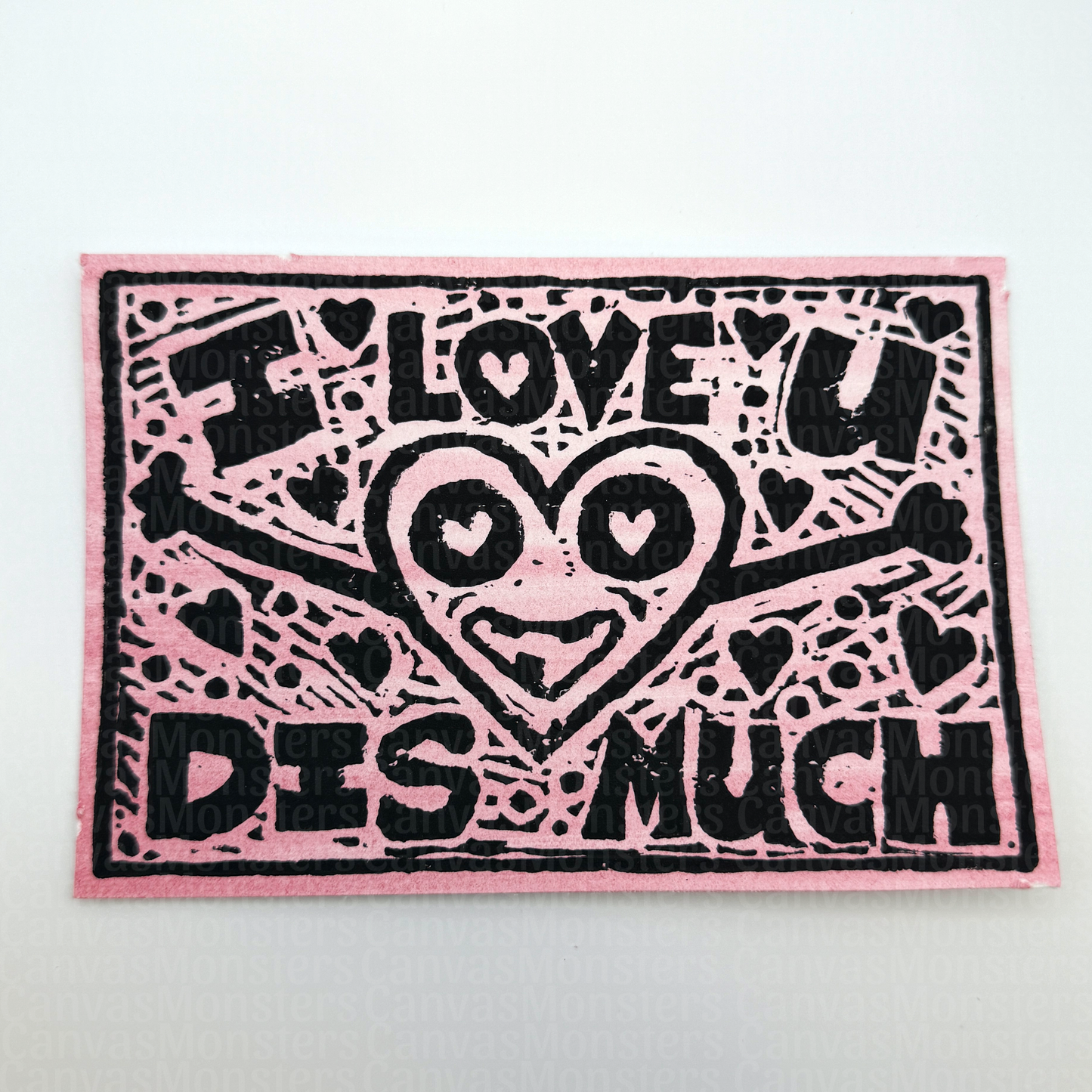 Pink paper stamped with 'I love u dis much' text and heart design, sitting on a white background
