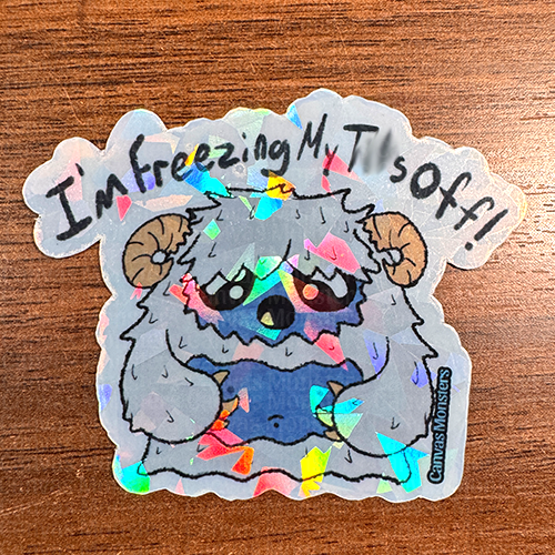 A sticker of a cartoon yeti character with text 'I'm freezing my tits off!' The background features a pattern of the same yeti character.