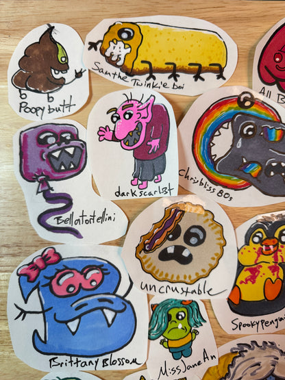 A collection of hand-drawn monster and character sticker cutouts arranged on a light wood surface. The stickers feature various colorful cartoon characters with handwritten usernames such as 'Poopy butt', 'Sam the Twinkle boy', 'dark scarlet', 'chrisbliss', 'bellatortellini', 'uncrustable', and 'Brittany Blossom'.
