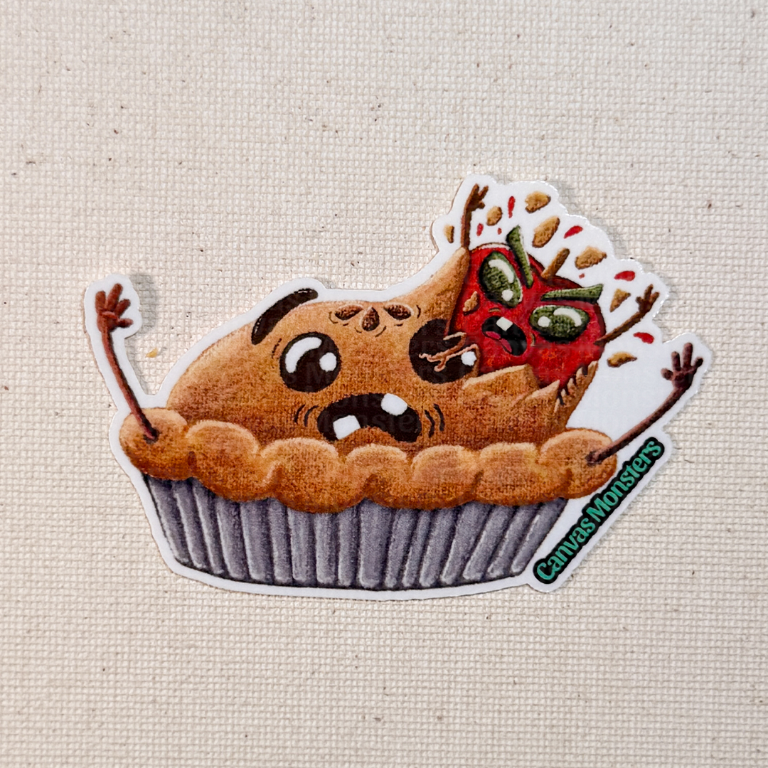 Glossy sticker of a cartoonish pie with a cartoon apple bursting out of it on a textured beige background