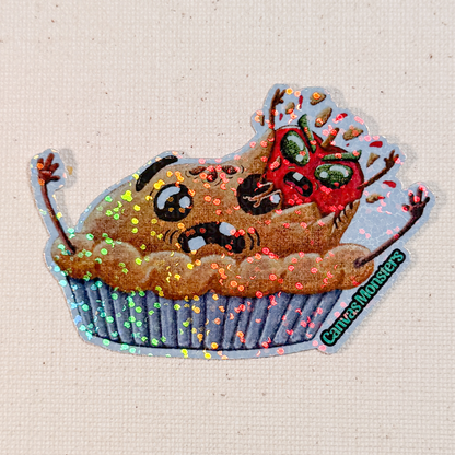 Glitter sticker of a cartoonish pie with a cartoon apple bursting out of it on a textured beige background