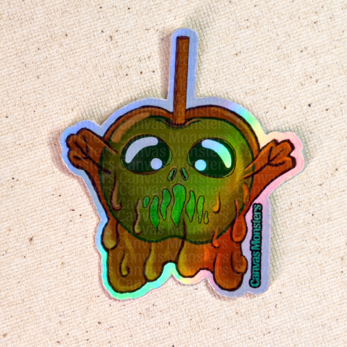 Holographic sticker of a green candy apple with arm, coated in brown caramel on a beige background