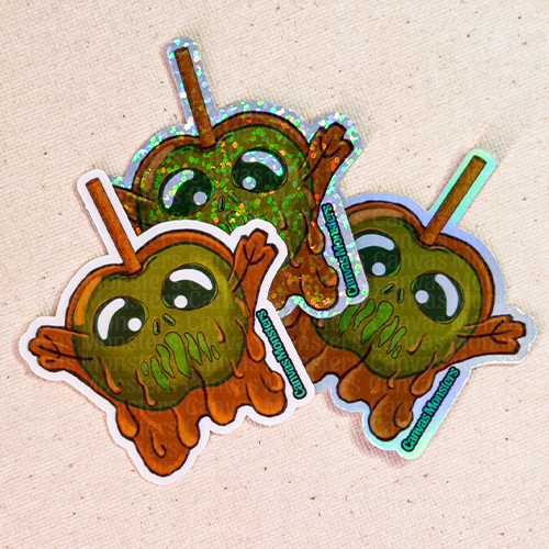 Three stickers (glossy, glitter, and holofoil) of candy apple shaped monster on a sticker