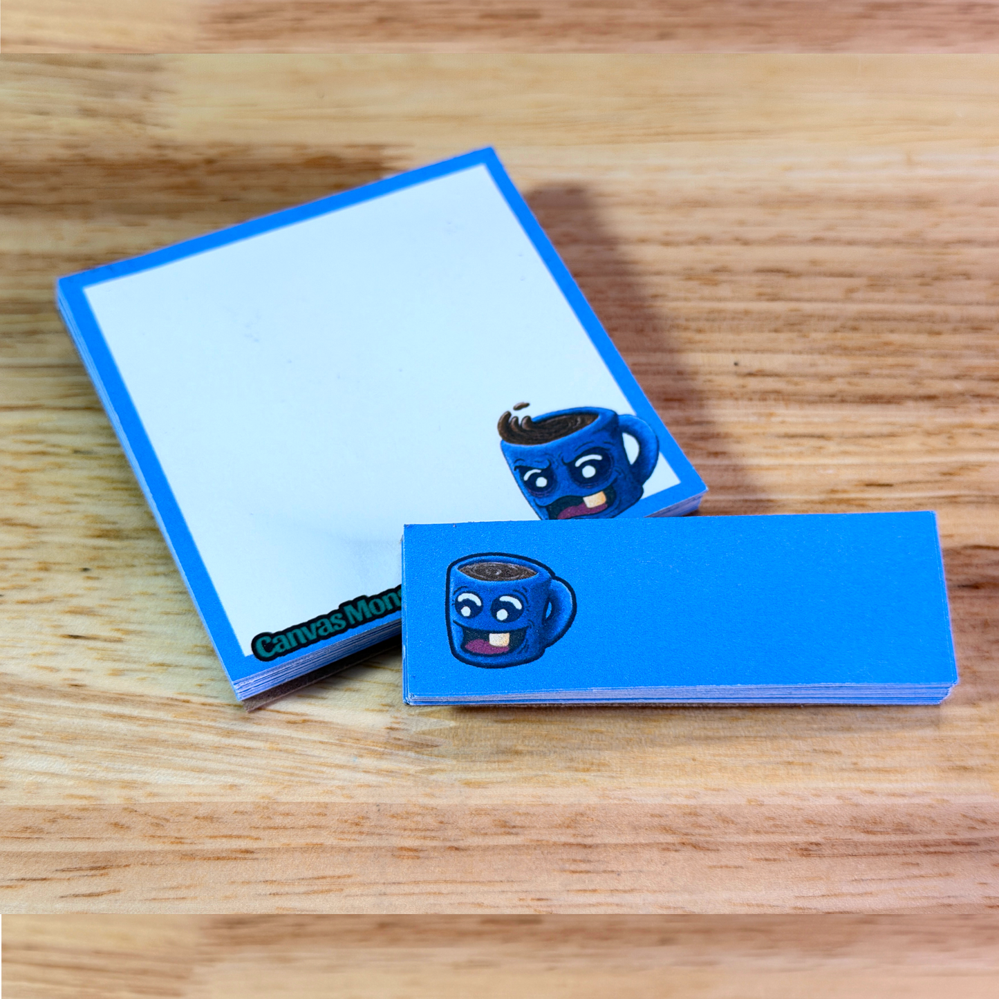 3x3 inch sticky note pad with a matching 1x3 inch sticky note pad sitting on top, both sitting on a wooden surface