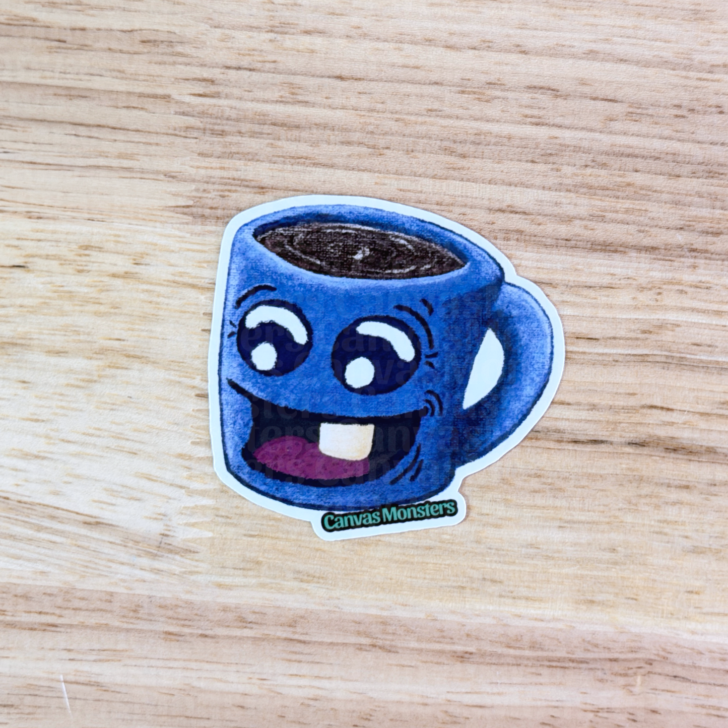 Sticker of a blue coffee cup with a happy face on a wooden surface