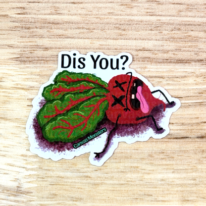 Sticker with a red and green characterized beet asking 'Dis You?' on a wooden surface
