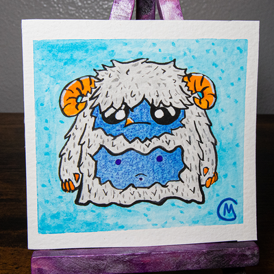 A watercolor painting of a yeti with blue and gray colors, framed in a purple and pink iridescent frame.