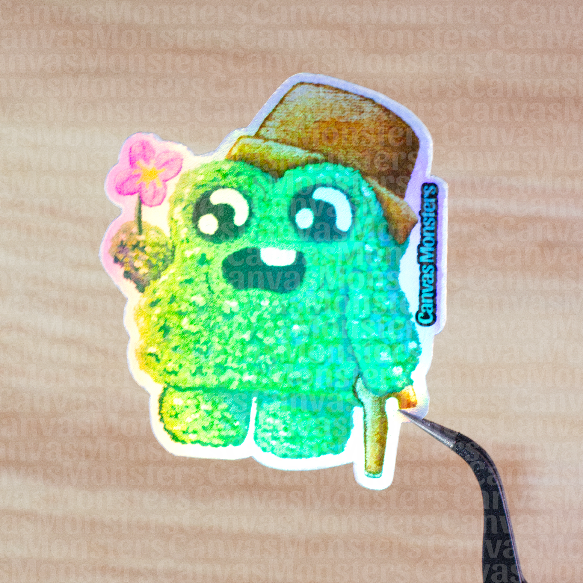 Holofoil sticker of a green shrub creature wearing a brown pot as a hat and holding a flower on a wooden surface