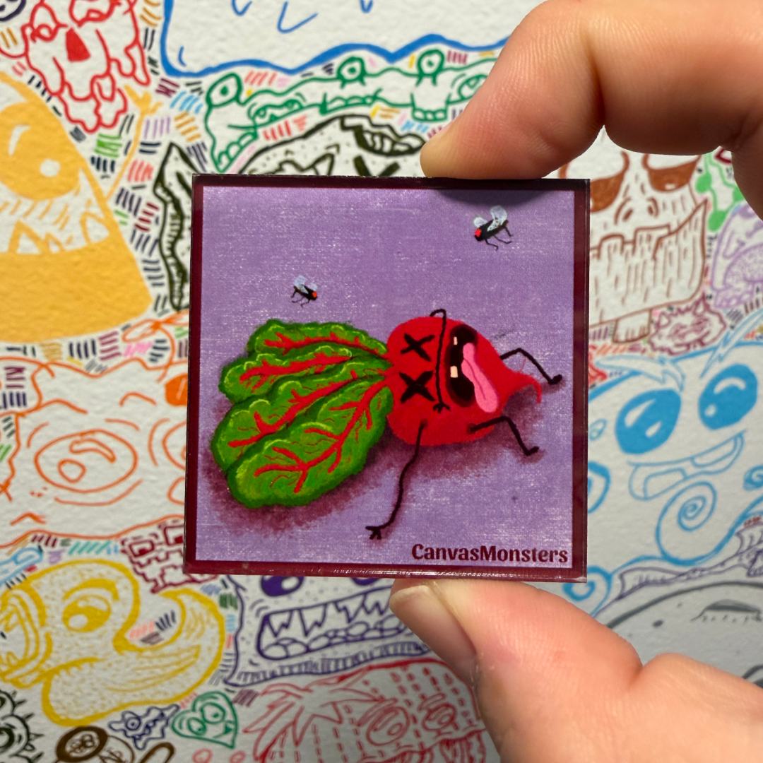 A hand holds a small square magnet featuring a cartoon red beet with leaf-shaped hair on a lavender background. The design has the text 'CanvasMonsters' at the bottom and is shown against a colorful hand-drawn patterned backdrop.