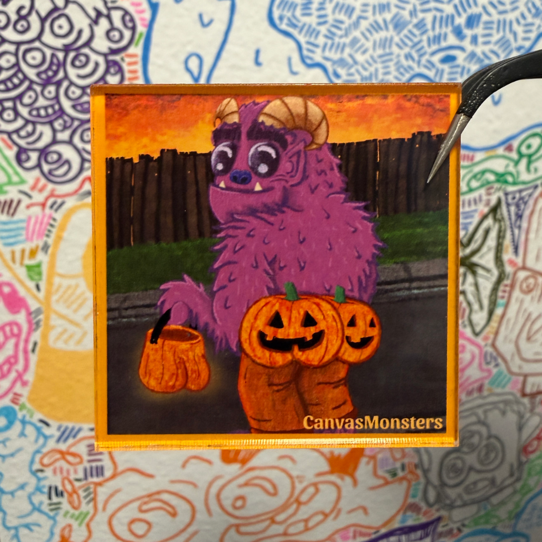 A square magnet with a purple furry monster with horns, wearing orange boots and with jack-o'-lantern pumpkins for butt cheeks, displayed on a patterned surface.