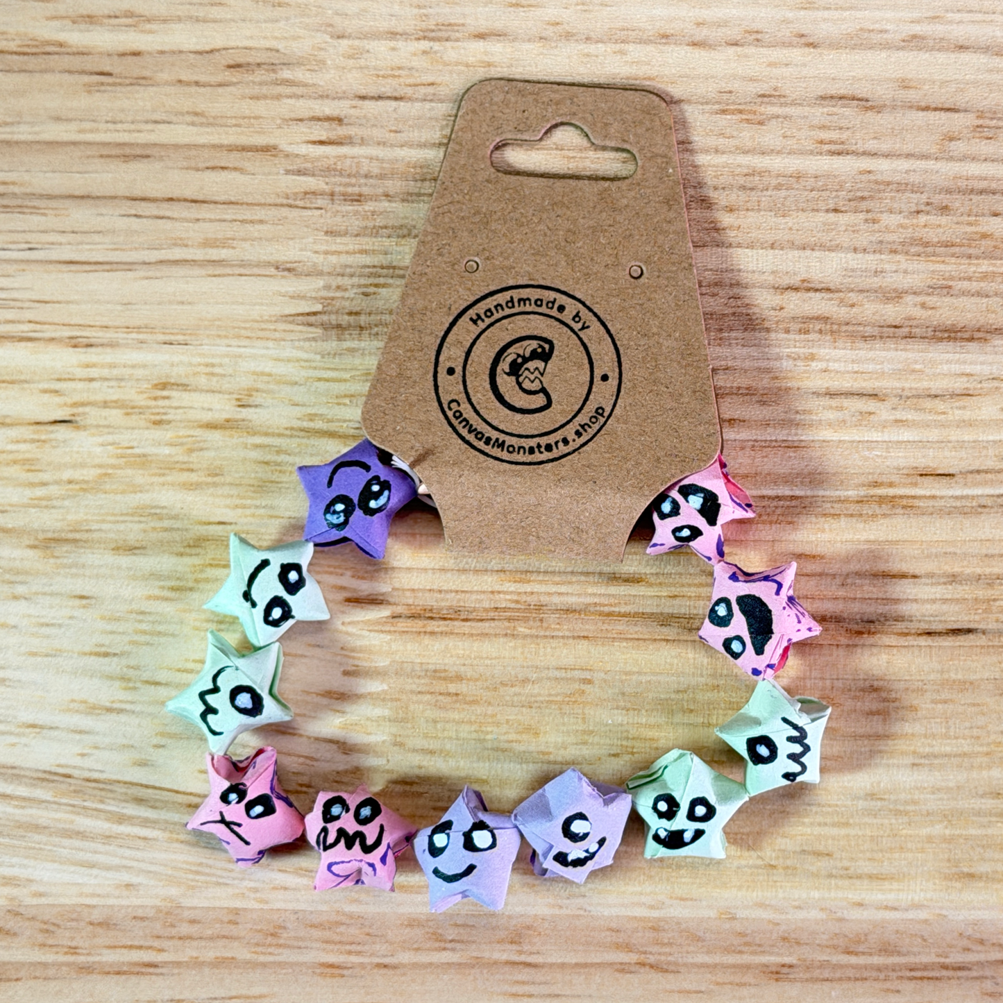 Bracelet with colorful paper origami star-shaped charms on a wooden background