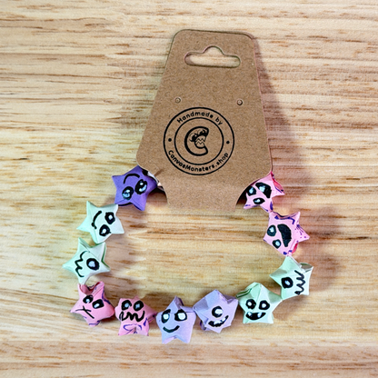 Bracelet with colorful paper origami star-shaped charms on a wooden background