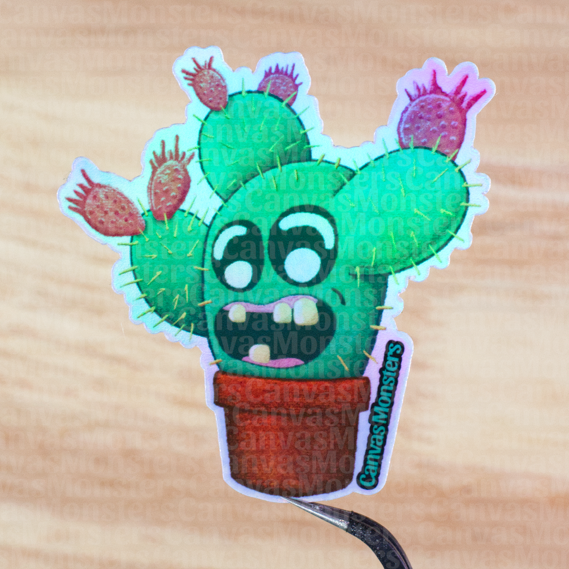 Holofoil sticker of a cartoon cactus character with a surprised expression held above a wooden surface