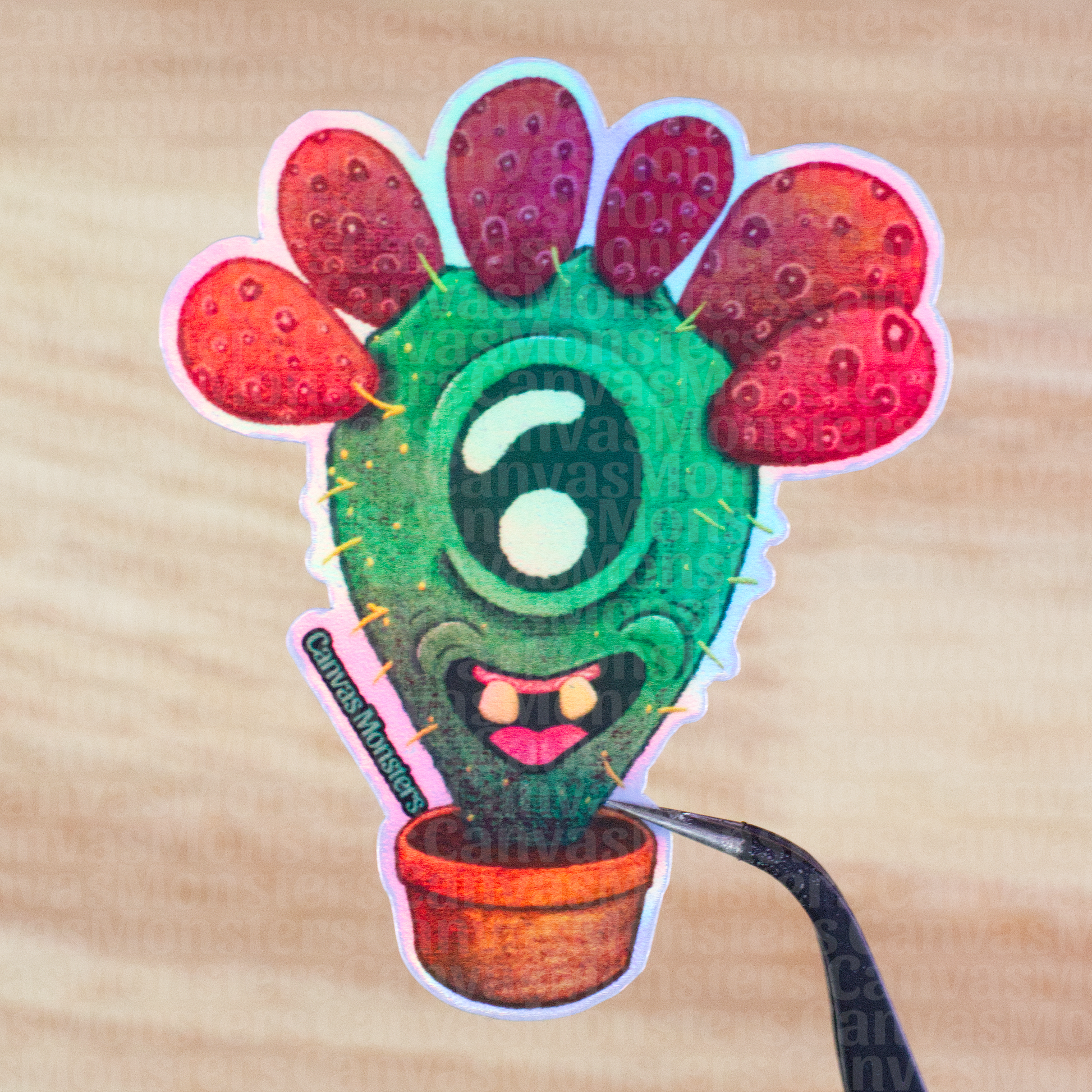 Holofoil sticker of a cactus character with a smiling face on a wooden surface.