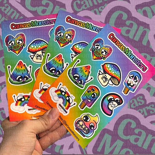 Hand holding three Canvas Monsters Pride sticker sheets