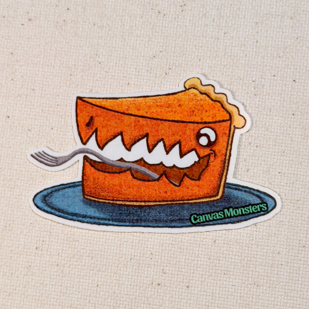 Glossy sticker of a cartoon pie with a face on a plate, branded 'Canvas Monsters', on a textured beige background