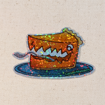Glitter sticker of a cartoon pie with a face on a plate, branded 'Canvas Monsters', on a textured beige background