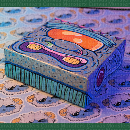 Colorful abstract Monster painting on a canvas block. Featuring a giant orange eye, blue skin, and silver highlights. 