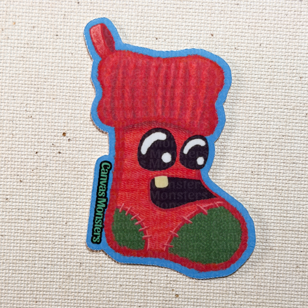 Red sock with cartoon face on a textured beige background