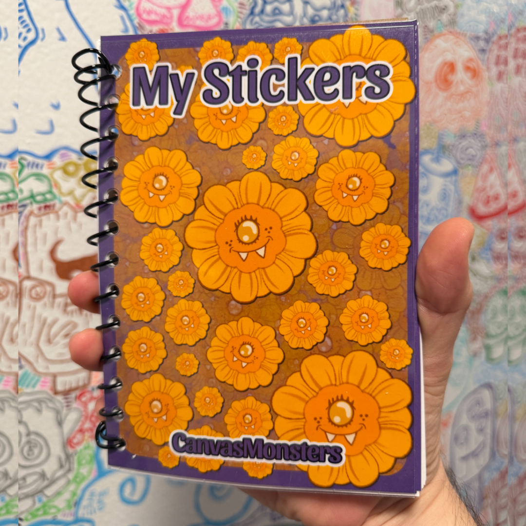 A hand holding a spiral-bound notebook titled 'My Stickers' featuring yellow cartoon flower stickers on a purple cover, with the brand name 'CanvasMonsters' at the bottom.