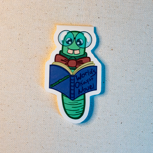 Magnetic bookmark featuring a bookworm character reading a book titled, "World's Okayst Novel"