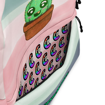 Close-up of a pastel backpack with a pink and mint striped design, a cartoon cactus in a pot on the front, and a patterned zip pocket featuring colorful skull motifs.