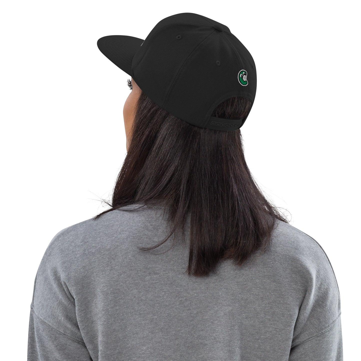 Person wearing a black cap with a logo on a white background