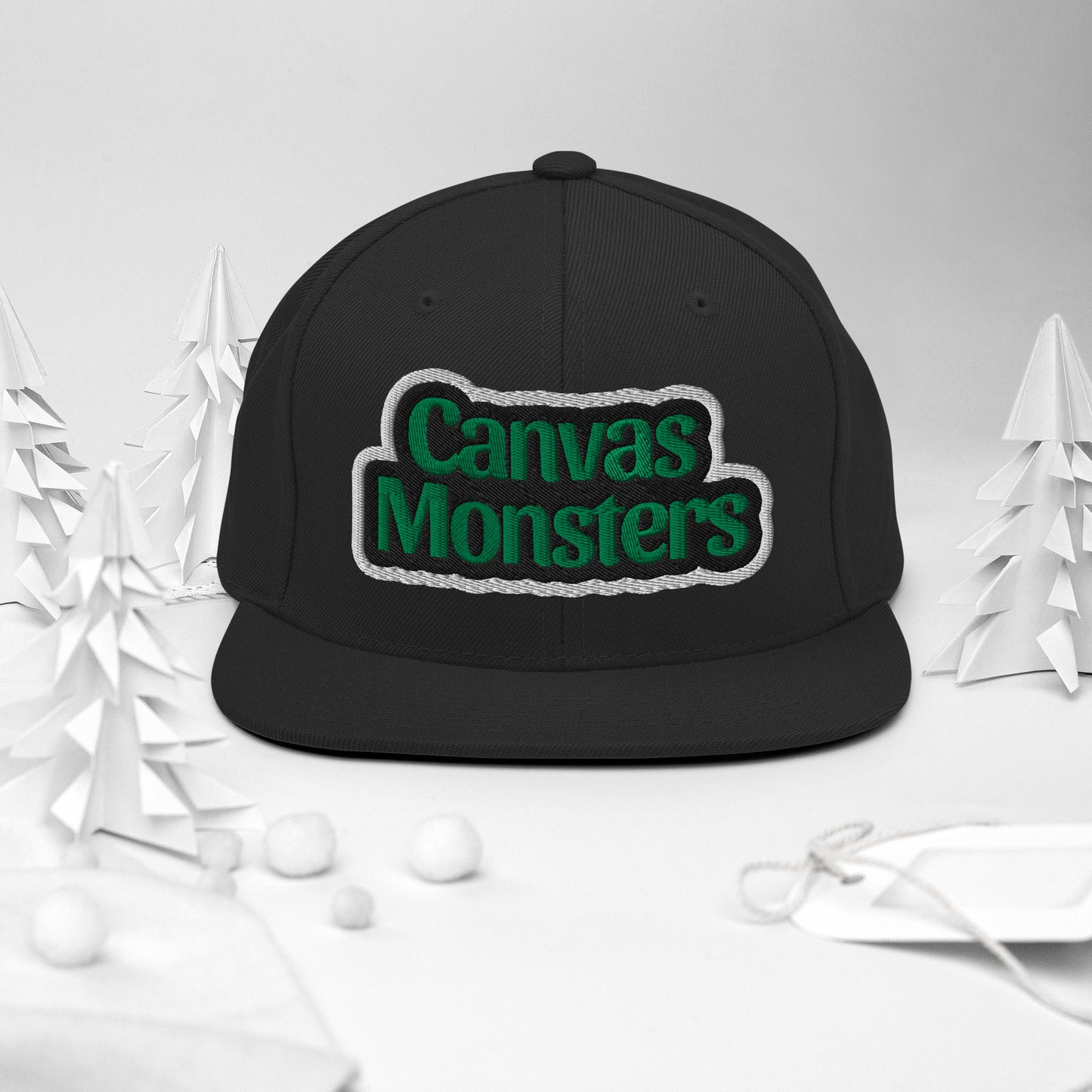 Black cap with 'Canvas Monsters' text on a white background