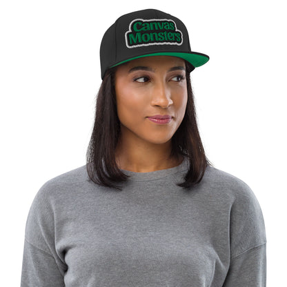 Woman wearing a black cap with 'Canvas Monsters' logo on a white background