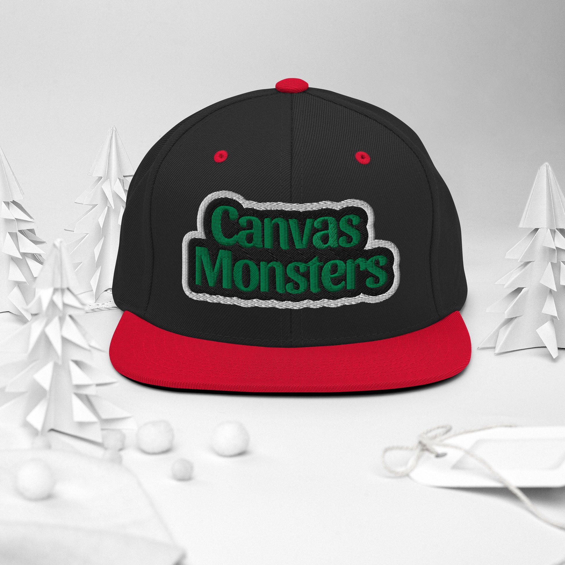 Black and red cap with 'Canvas Monsters' text on a white background