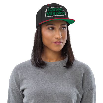 Woman wearing a black cap with 'Canvas Monsters' logo on a white background