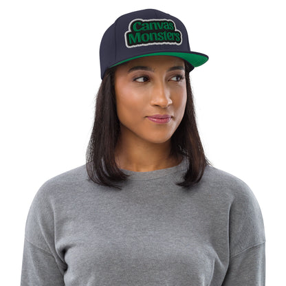 Woman wearing a navy cap with 'Canvas Monsters' logo on a white background