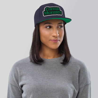 Person wearing a cap with 'Canvas Monsters' logo on a plain background