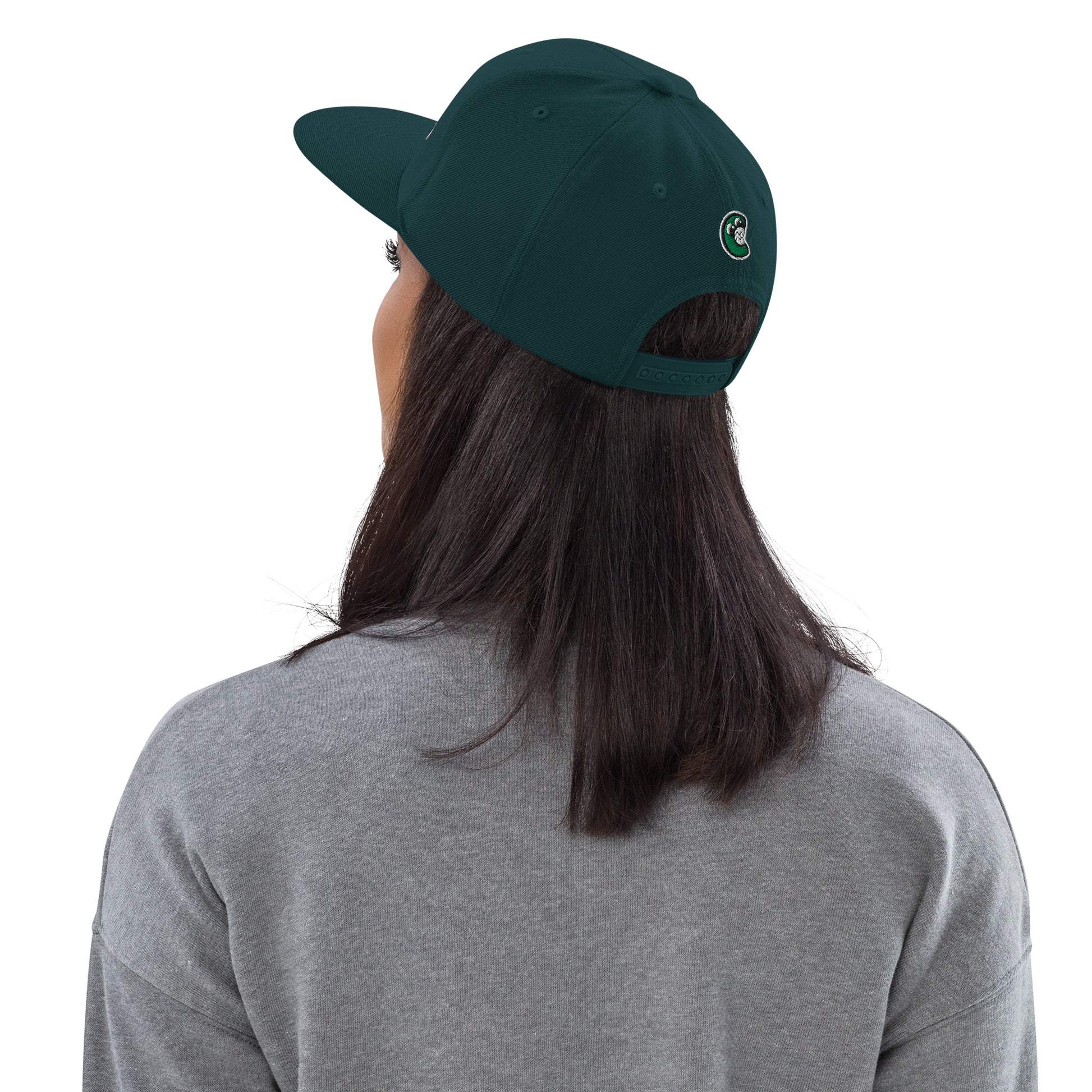 Person wearing a green cap with a logo on a white background