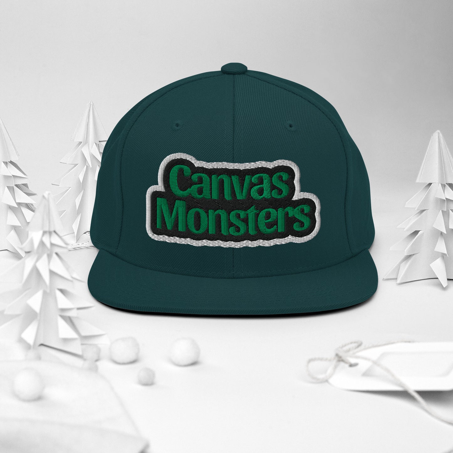 Green cap with 'Canvas Monsters' text on a white background