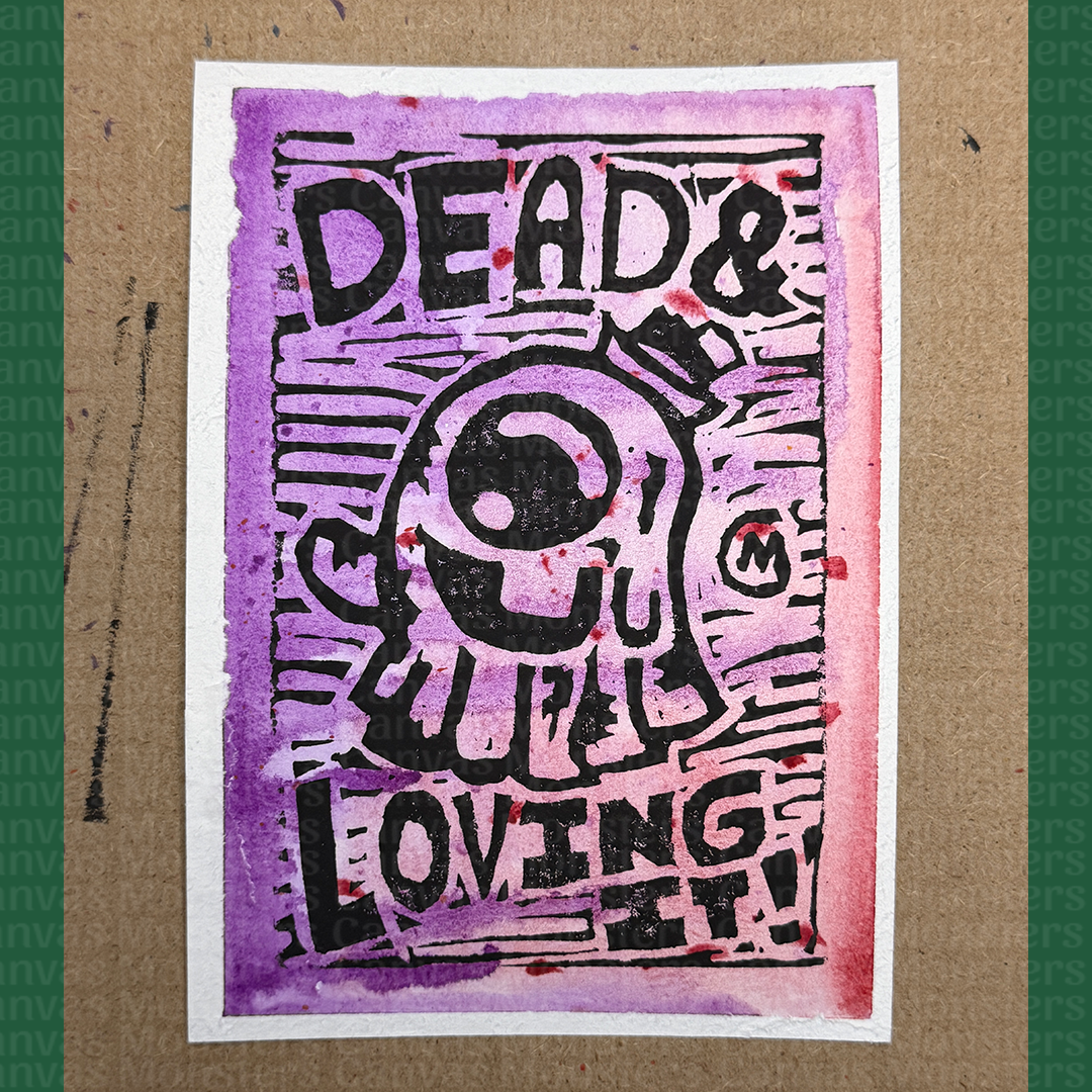 Artistic print with text 'DEAD & LOVING IT!' on a textured surface