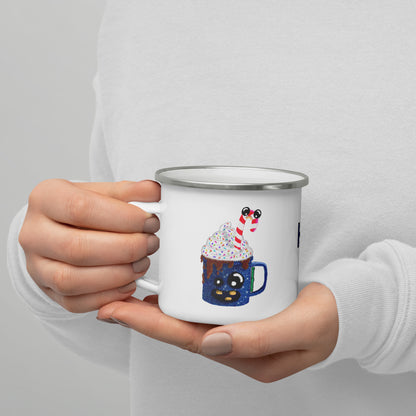 Person holding a white camper mug with a festive design on a plain background