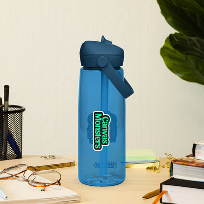 Blue water bottle with 'Canvens Monsters' logo on a desk with glasses and books.