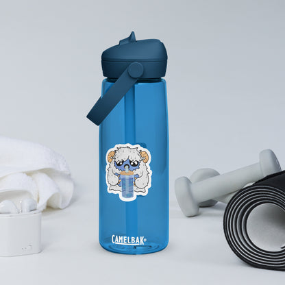 Blue Camelbak water bottle with a cartoon yeti also drinking from a water bottle, sitting on a white surface with gym accessories.