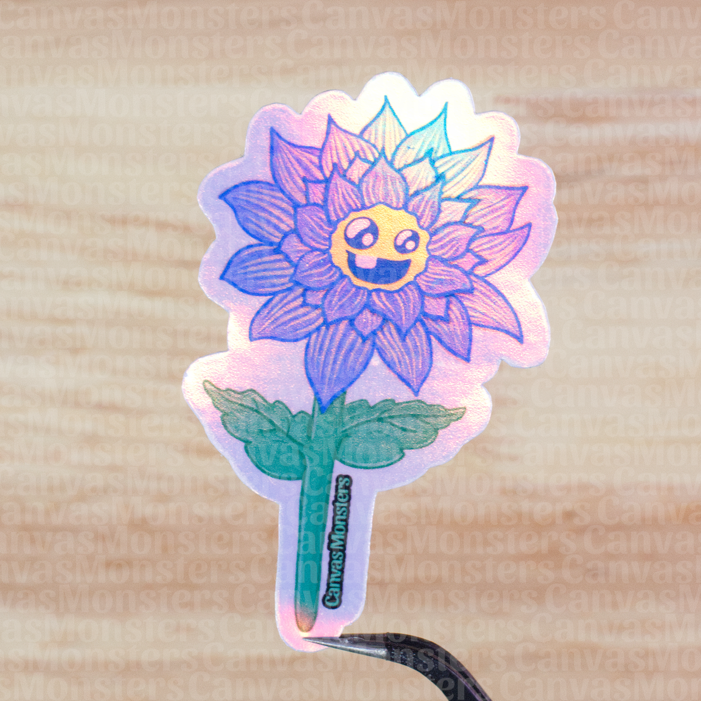 Holographic sticker of a blue flower with a smiley face on a wooden surface
