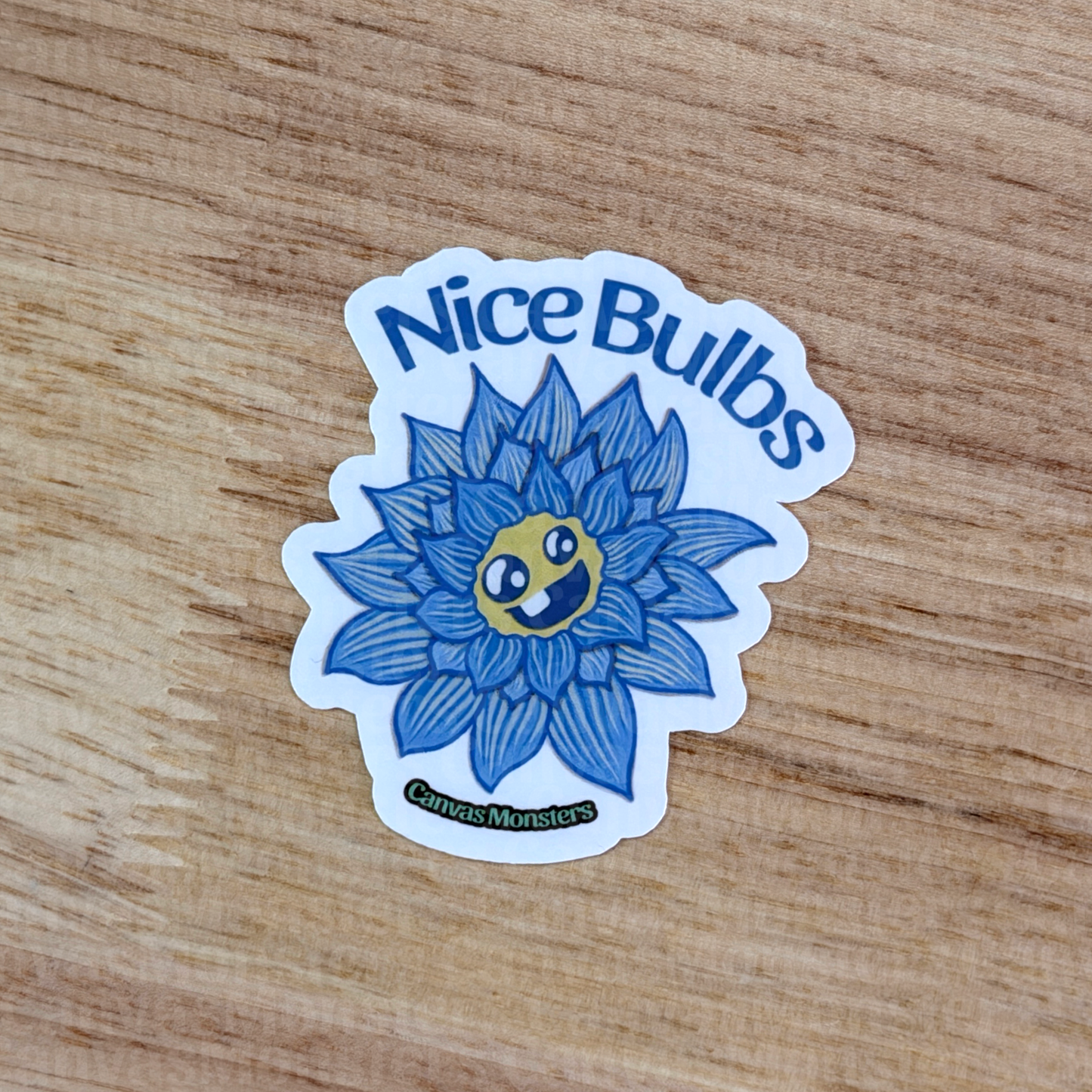 Sticker with a blue flower design and 'Nice Bulbs' text on a wooden surface